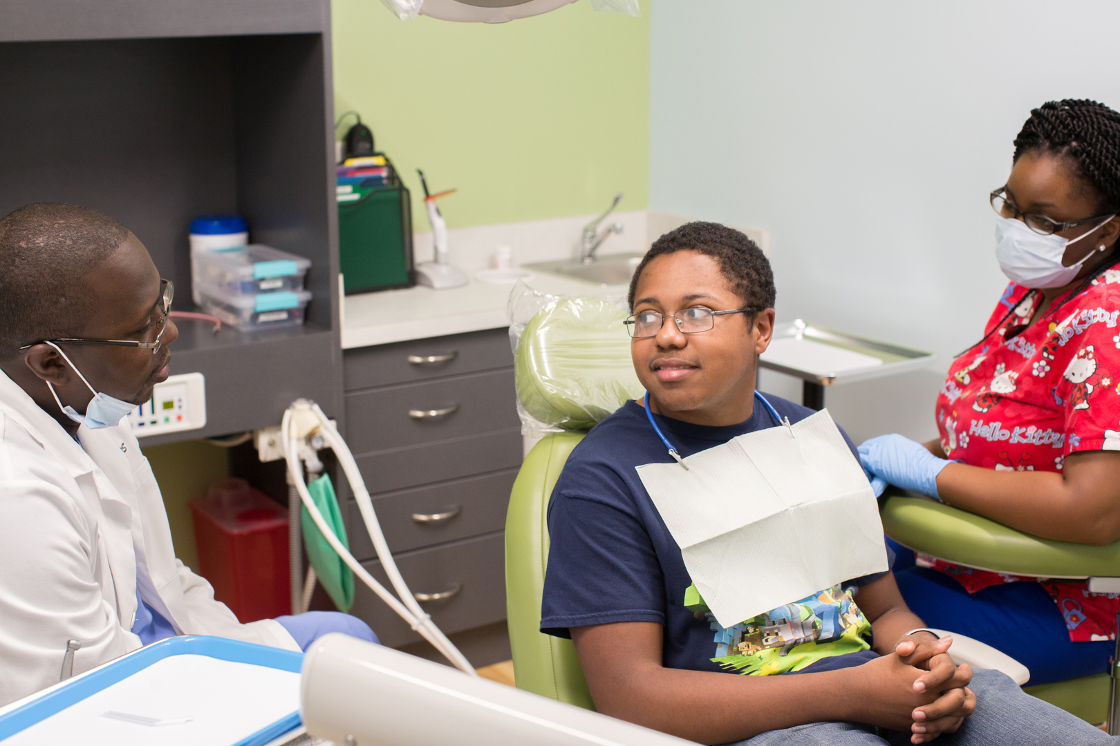 A young man sitting in the dentist chair.