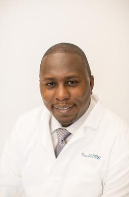 A man in white lab coat and tie.